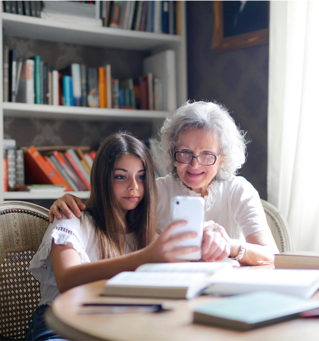 Lady with grandaughter looking at phone