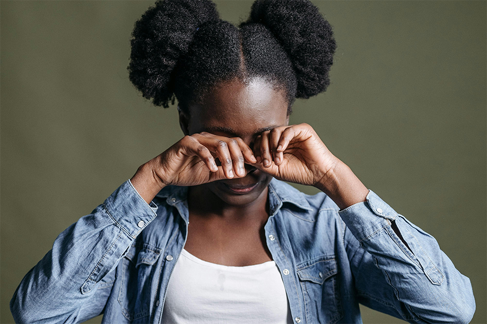 Girl rubbing her eyes