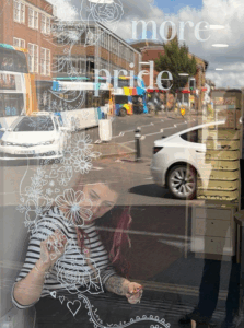 Kat decorating a window