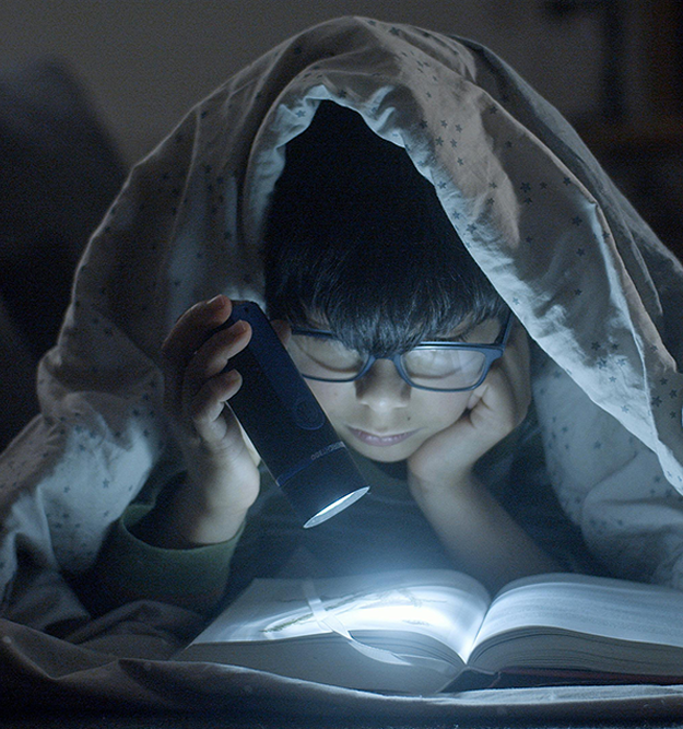child reading under duvet